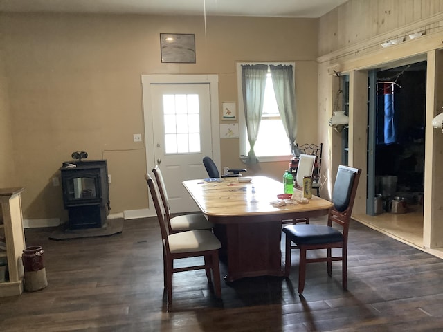 dining area featuring a wood stove and dark hardwood / wood-style floors