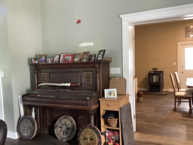 miscellaneous room with hardwood / wood-style floors and a wood stove