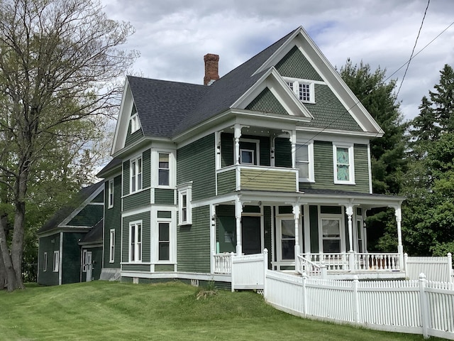 view of front of home with a porch and a front lawn