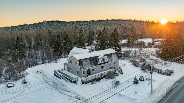 snowy aerial view with a forest view