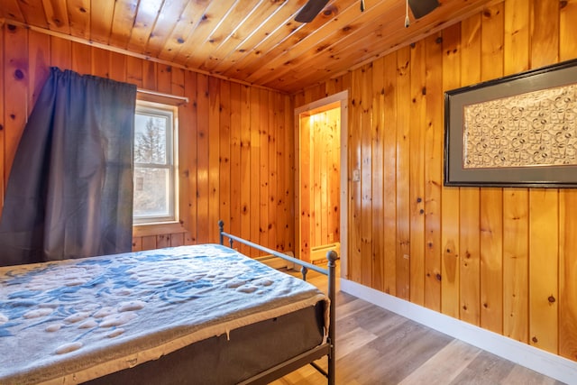 bedroom featuring wood-type flooring, wooden ceiling, and wood walls