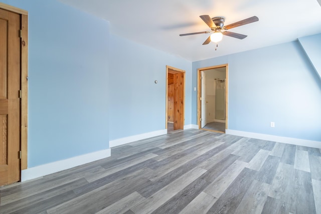 interior space with light wood-style floors, baseboards, and ceiling fan