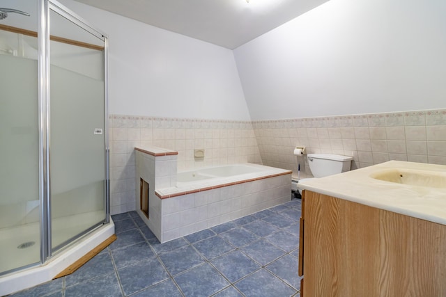 full bathroom with tile walls, vanity, plus walk in shower, tile patterned floors, and toilet