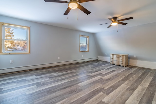 spare room with hardwood / wood-style flooring and a baseboard heating unit