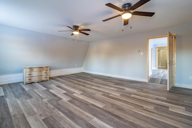 unfurnished bedroom with a ceiling fan, wood finished floors, and baseboards