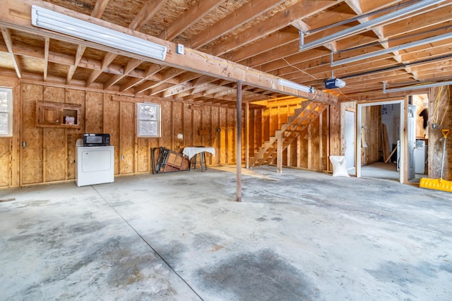 garage with washer / dryer and a garage door opener