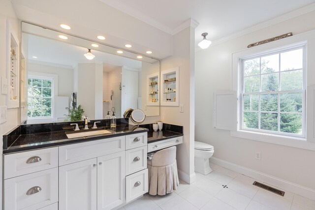 bathroom featuring vanity, toilet, tile patterned floors, and crown molding