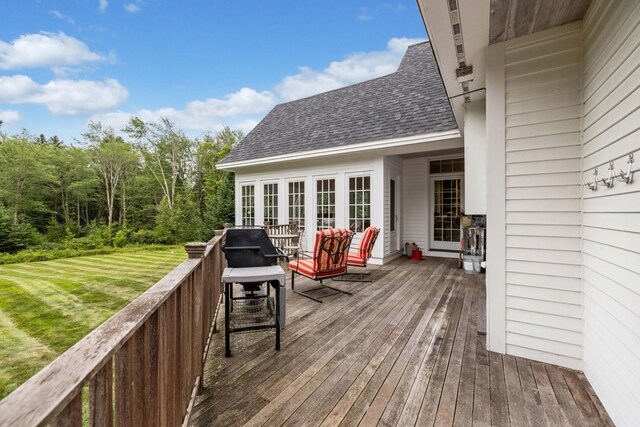 deck featuring french doors and a lawn