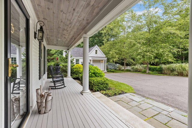 wooden terrace featuring a garage