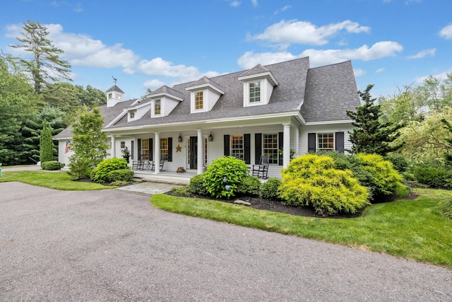 new england style home featuring covered porch