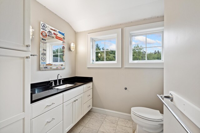 bathroom featuring tile patterned floors, toilet, and vanity