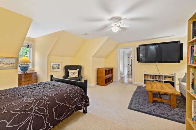 carpeted bedroom featuring ceiling fan and vaulted ceiling