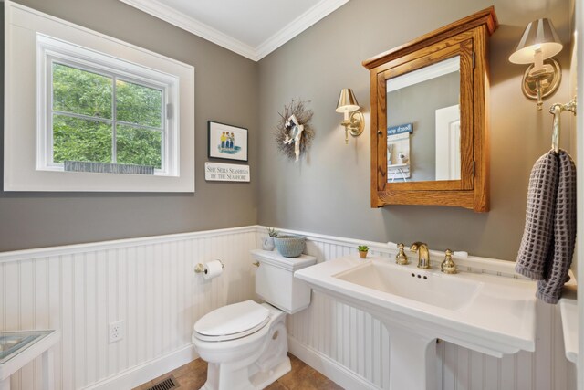 bathroom with sink, toilet, crown molding, and tile patterned flooring