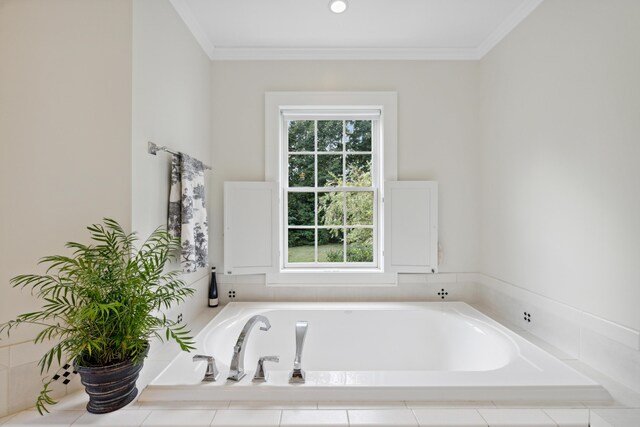 bathroom featuring a relaxing tiled tub and ornamental molding