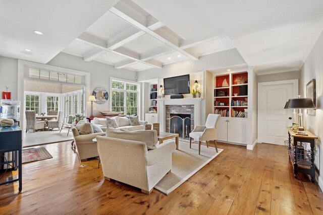 living room featuring beamed ceiling, light hardwood / wood-style flooring, and coffered ceiling