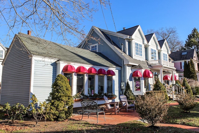 30 Ocean Ave, Kennebunkport, ME 04046 - back of property featuring a patio, a chimney, and roof with shingles