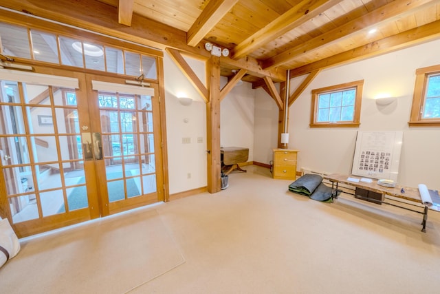 interior space with french doors, beam ceiling, and wood ceiling