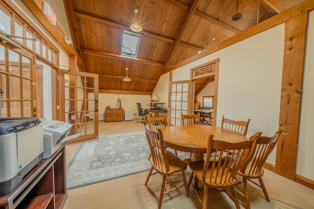 carpeted dining area with french doors, wooden ceiling, and vaulted ceiling with skylight