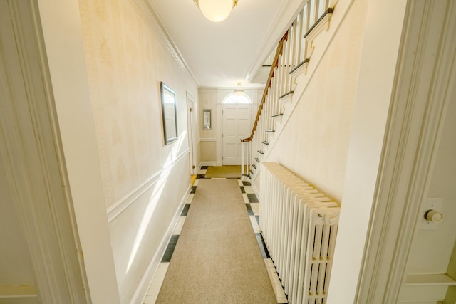 corridor featuring radiator heating unit and ornamental molding