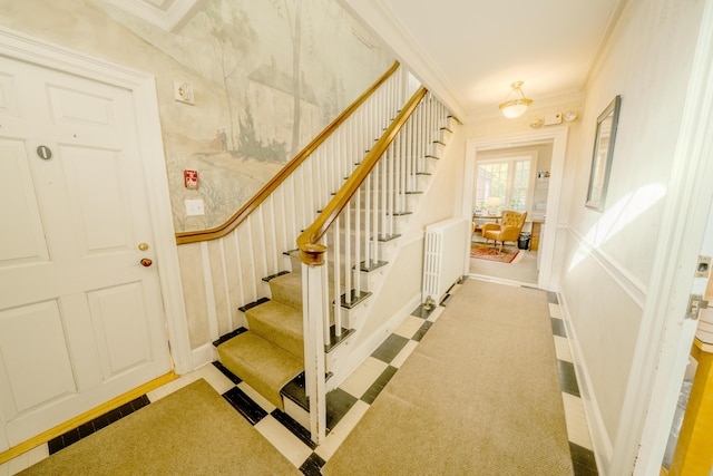 stairway featuring ornamental molding and radiator heating unit