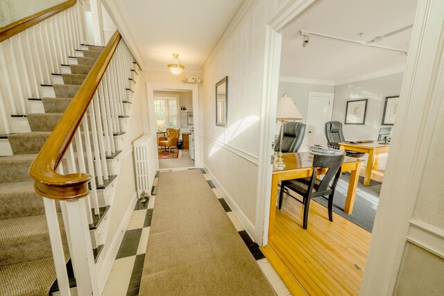 corridor with radiator and ornamental molding