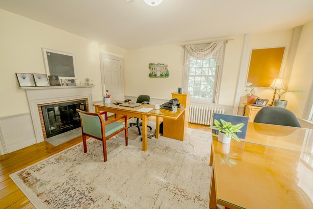 office area featuring light wood-type flooring and radiator