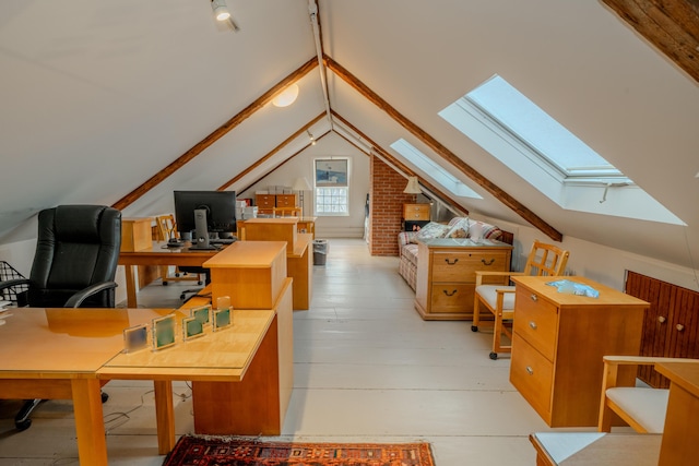 interior space featuring light hardwood / wood-style floors and lofted ceiling with skylight