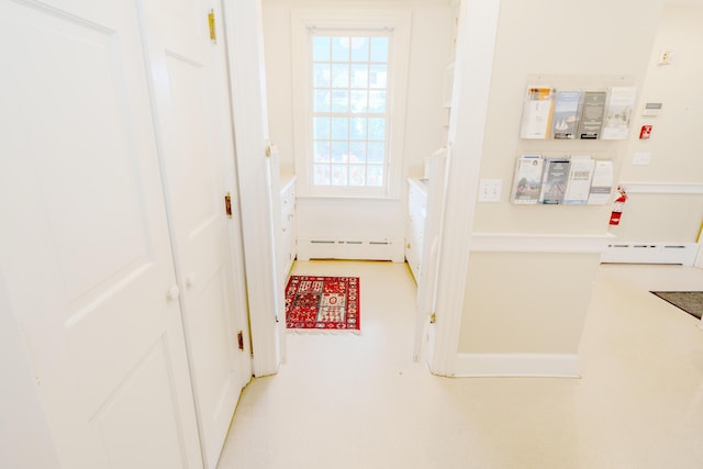 corridor featuring a wealth of natural light and a baseboard radiator