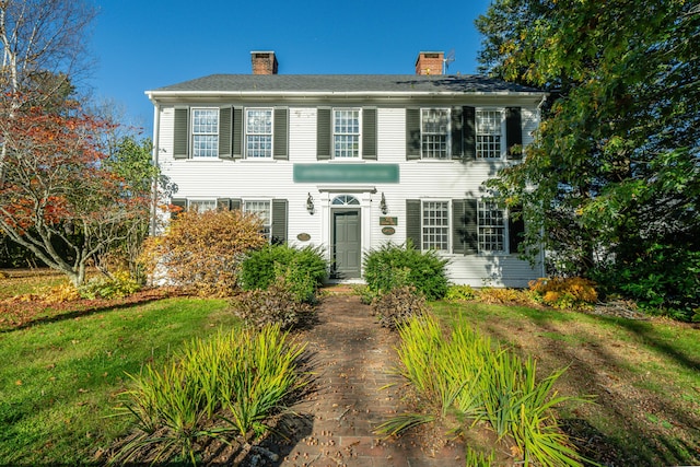 colonial home with a front lawn