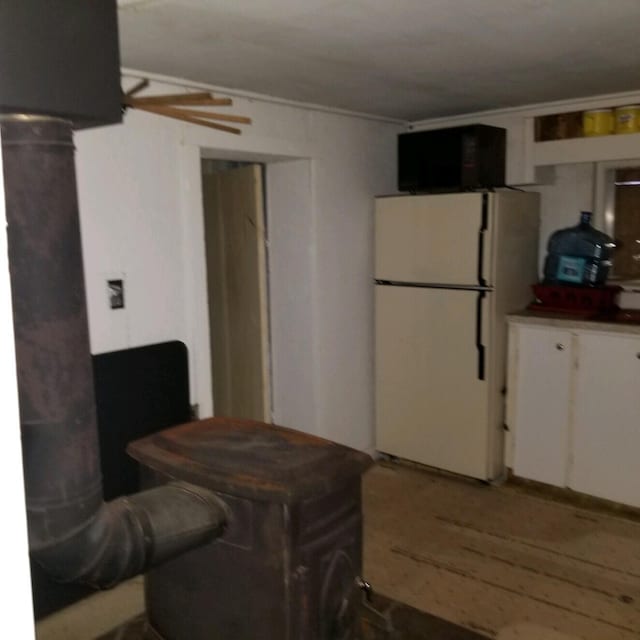 kitchen with white fridge and white cabinetry