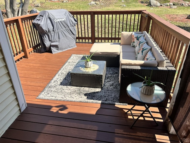 wooden deck with grilling area and an outdoor living space