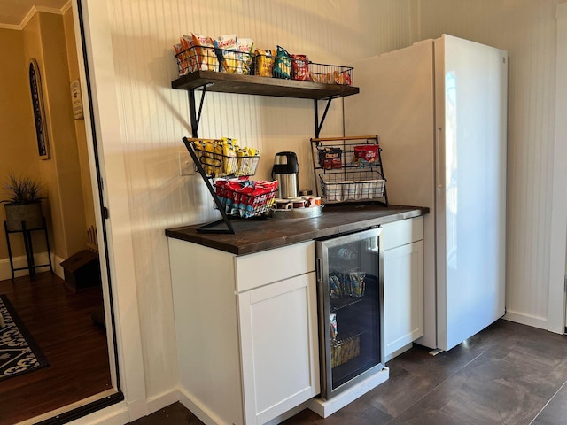 bar with white cabinetry and wine cooler