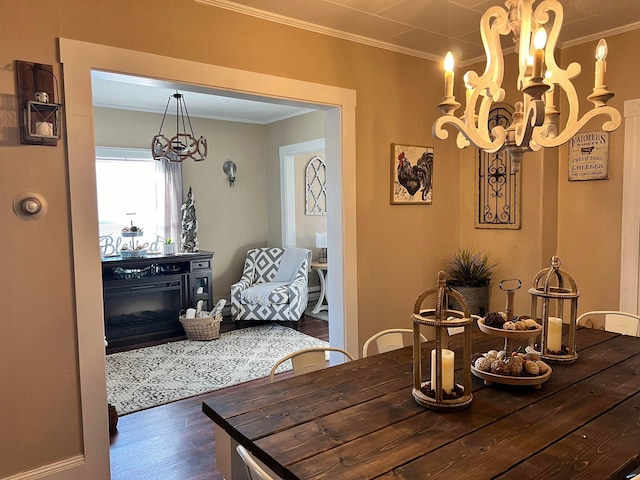 dining room with dark hardwood / wood-style flooring, crown molding, and a notable chandelier