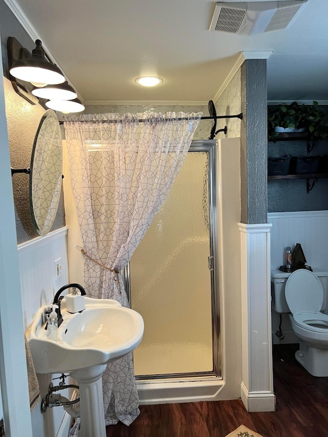 bathroom featuring hardwood / wood-style flooring, walk in shower, and ornamental molding