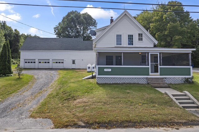 view of front facade featuring a front yard and a sunroom