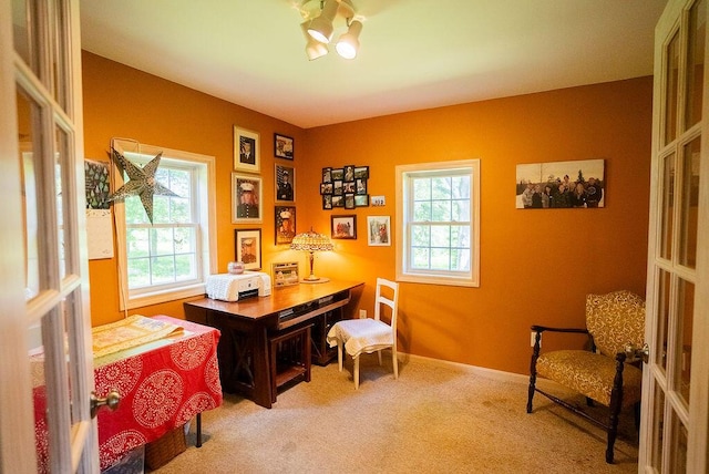 home office with carpet flooring, french doors, and a healthy amount of sunlight