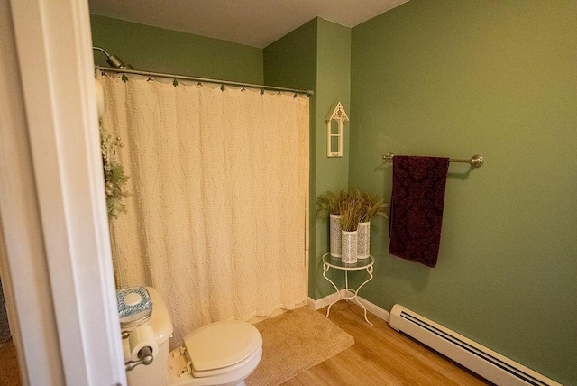 bathroom with hardwood / wood-style flooring, toilet, and a baseboard heating unit