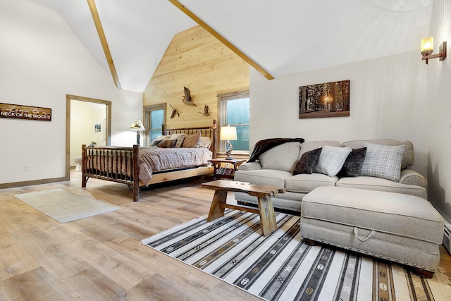 bedroom with hardwood / wood-style flooring, wooden walls, and high vaulted ceiling