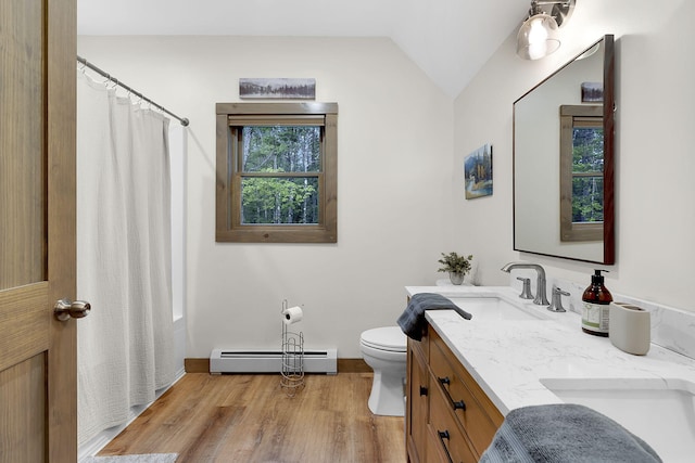 bathroom with a baseboard radiator, lofted ceiling, wood-type flooring, vanity, and toilet