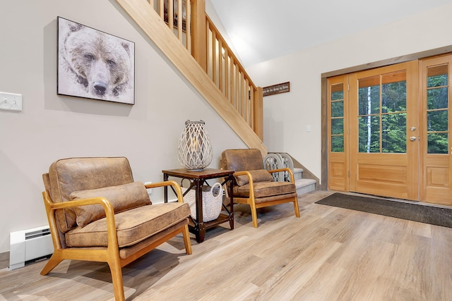 entrance foyer featuring baseboard heating and light hardwood / wood-style floors