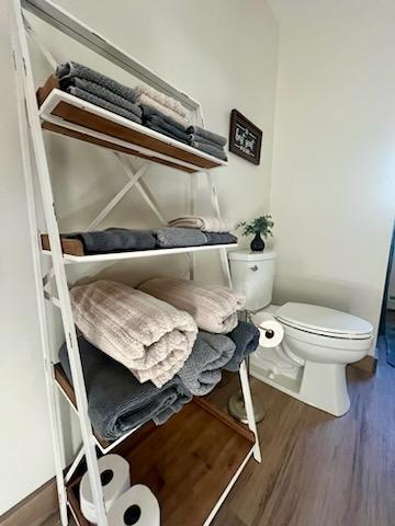 bathroom featuring toilet and hardwood / wood-style flooring