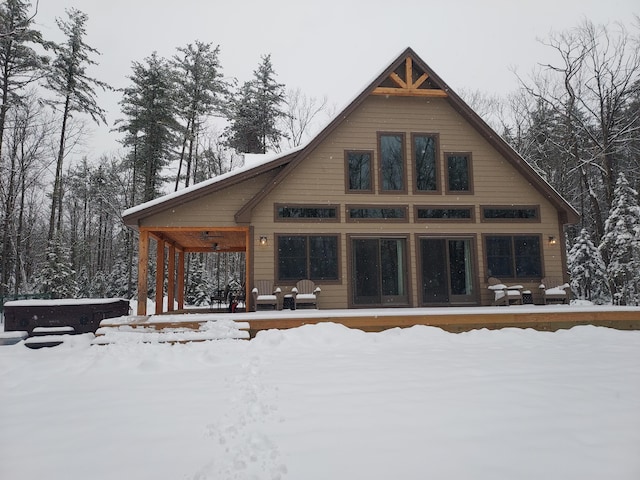 view of snow covered back of property