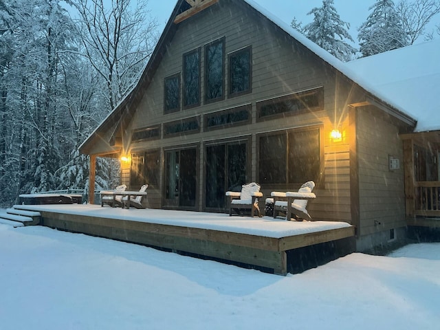 view of snow covered back of property