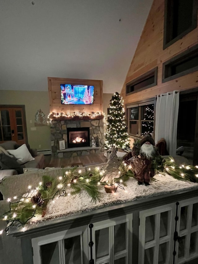 bar with lofted ceiling, a fireplace, and a baseboard radiator