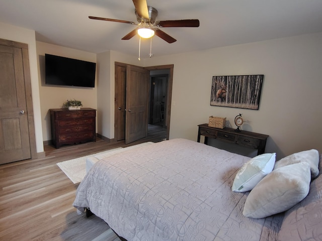 bedroom featuring a ceiling fan and light wood-type flooring