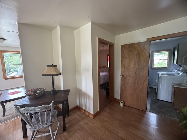 interior space featuring dark wood-type flooring, baseboard heating, and plenty of natural light