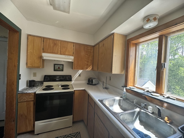 kitchen featuring electric stove, sink, and light tile patterned flooring