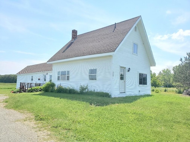 back of house with a lawn