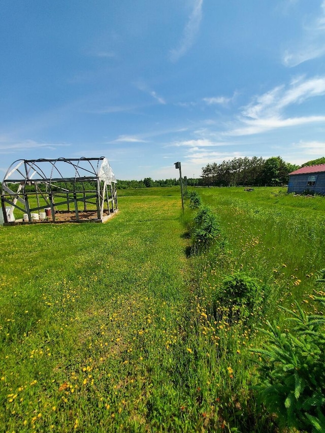 view of yard featuring an outbuilding and a rural view