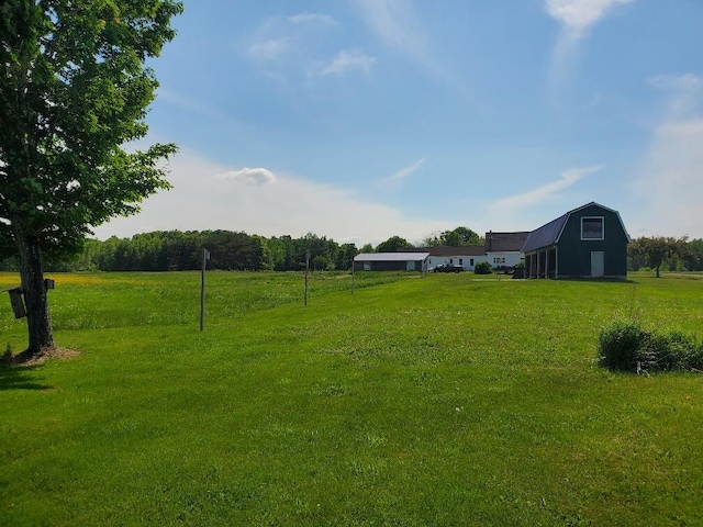 view of yard featuring an outbuilding and a rural view